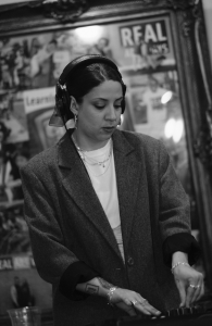 A woman behind a DJ set table.